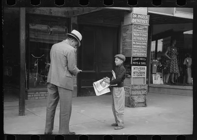 Newsboy on main street, Montrose, Colorado, 1939