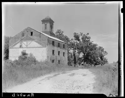 Photograph from Louisiana: Abandoned sugarcane warehouse. Placquemines…