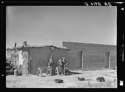 Rehabilitation clients. Mexican jacal on left in which they formerly…, New Mexico, 1936