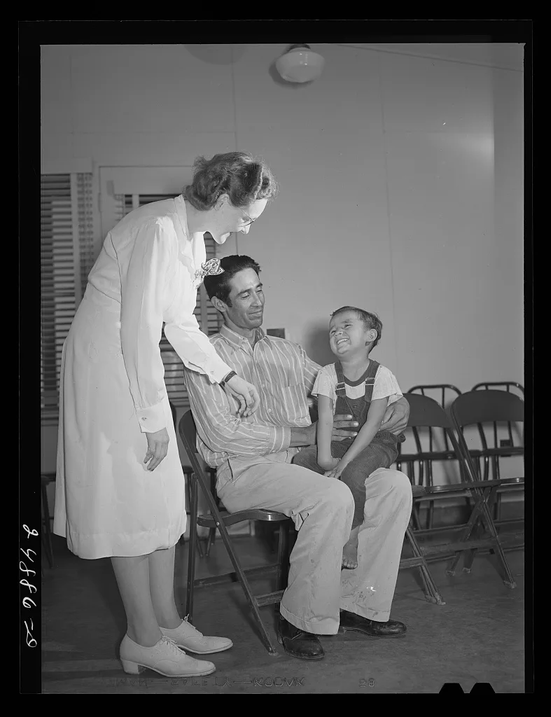 Doris Dill, nurse, and patient in clinic. Robstown camp, Texas, 1942