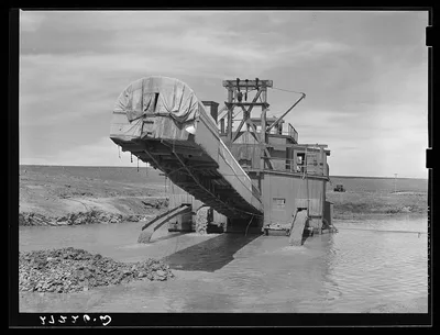 Dredge used in placer gold mining. Madison County, Montana, 1939