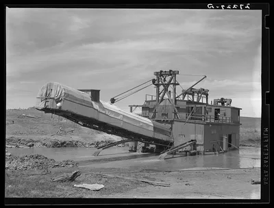 Dredge used in placer gold mining. Madison County, Montana, 1939