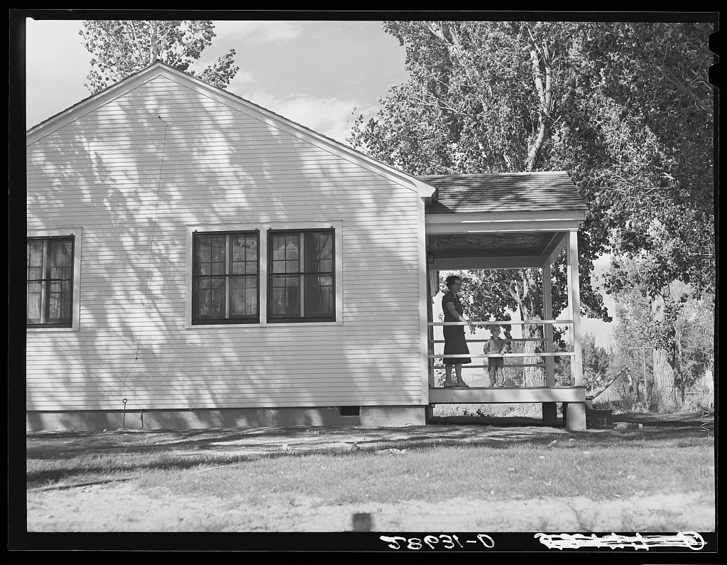 Mrs. Carl Higgins, wife of tenant purchaser, and son on porch of…, Colorado, 1939
