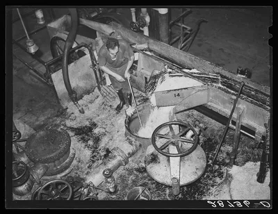 Loading diffusion chamber with sugar beet pulp in factory at…, Colorado, 1939
