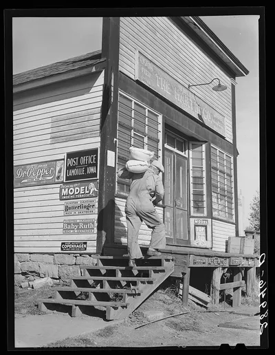 [Untitled photo, possibly related to: Carrying bags of flour out of…, Iowa, 1939