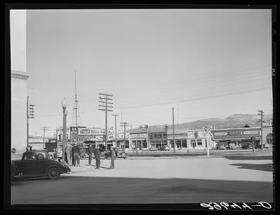 Cowhands on street corner. Elko, Nevada, 1940