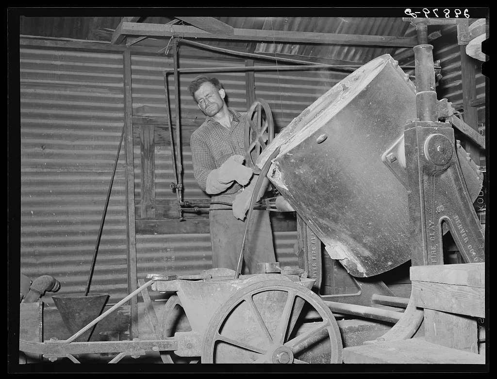 Pouring molten gold into brick. El Dorado Canyon, Clark County, Nevada, 1940