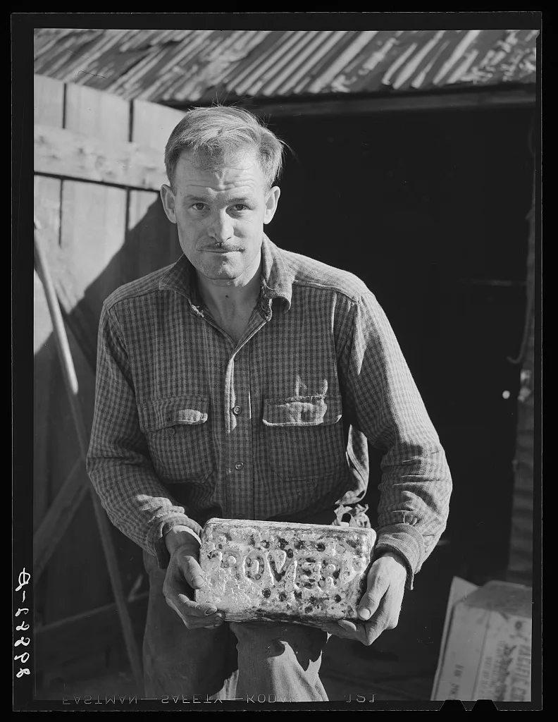 Miner with gold and silver brick worth about 2,000 dollars. El Dorado…, Nevada, 1940